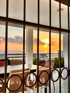 a dining room with a view of the ocean at Villa Sounine Rafraf in Bizerte