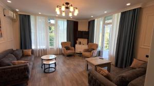 a living room with a couch and chairs and a table at Villa TG for Large Families with Private Pool in Batumi