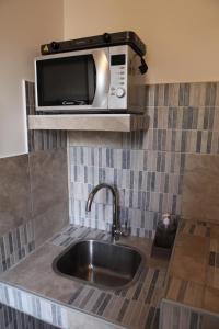 a kitchen with a sink and a microwave at Casa Dante in Vitorchiano +14 photos