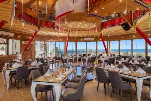 a dining room with tables and chairs and windows at Seagull Beach Resort - Families and Couples Only in Hurghada