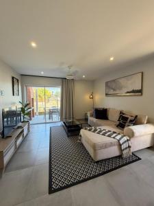 a large living room with a bed and a couch at SixtyOneAt1- George Central in George