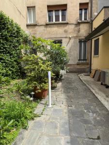 a stone walkway in front of a building at Guest House Broletto in Milan