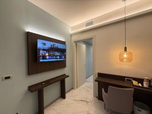 a living room with a tv on a wall at Guest House Broletto in Milan