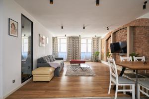 a living room with a couch and a table at Apartament Gold 2 in Złotoryja