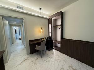 a corridor of a hotel with a desk and a chair at Guest House Broletto in Milan