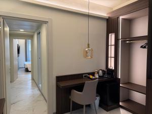a kitchen with a desk and a chair in a room at Guest House Broletto in Milan