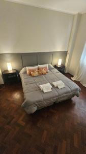 a bedroom with a large bed with two towels on it at En Espejo in Mendoza