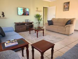 a living room with a couch and a table at The Cottage in Lilongwe