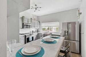 a kitchen with a table and chairs and a refrigerator at Arcadian Place in Port-of-Spain