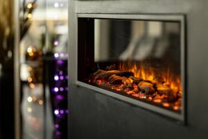 a fireplace with some food cooking in it at Rosenlund Hamn in Sande