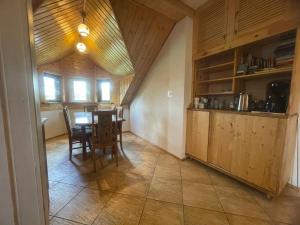 a kitchen with a table and a dining room at Agroturystyka Świt dobry in Strzebowiska