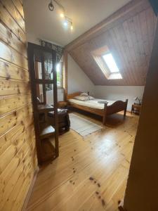a bedroom with a bed in a attic at Agroturystyka Świt dobry in Strzebowiska