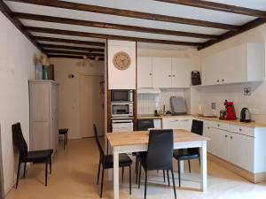 a kitchen and dining room with a table and chairs at AGREABLE APPARTEMENT in Eaux-Bonnes