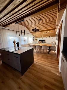 a kitchen and dining room with wooden ceilings and a table at Bergheimat Stüble Allgäu in Bad Hindelang +17 photos