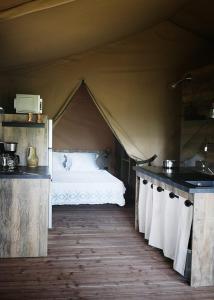 a bedroom with a bed in a tent at Domaine l Alba Scelta in Ucciani