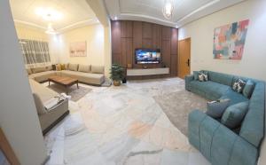 a living room with two couches and a tv at App najoua in Safi