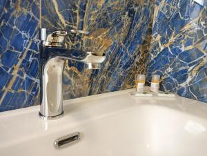 a sink with a faucet in a bathroom at Sleep & Fly Villa Ornella in Case Nuove