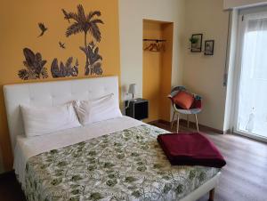 a bedroom with a large bed and a chair at Sleep & Fly Villa Ornella in Case Nuove +19 photos