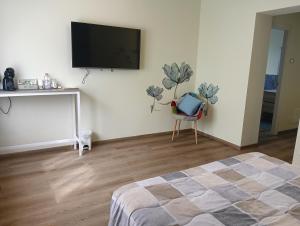 a bedroom with a flat screen tv on a wall at Sleep & Fly Villa Ornella in Case Nuove