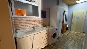 a bathroom with a sink and a washing machine at Villa Gersina Golem in Golem +91 photos