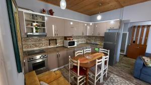 a kitchen with a table and a dining room at Villa Gersina Golem in Golem