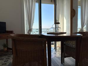 a dining table and chairs with a view of the ocean at Le Petit Café L'arriere Cour in Cancale +25 photos