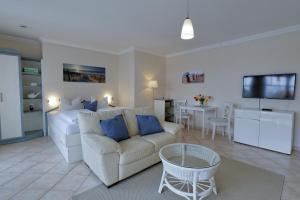 a living room with a couch and a living room with a kitchen at Strandhaus Brunhild in Timmendorfer Strand
