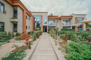 a walkway in front of a building with flowers at Heaven Boutique Hotel in Kigali