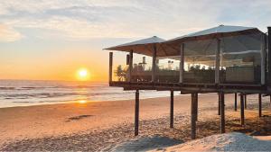 a lifeguard station on the beach at sunset at Strandweg Appartement in Buren