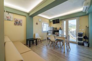 a living room with a couch and a table at Vista Mare Apartments in Giardini Naxos