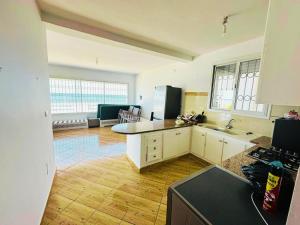 a kitchen with a sink and a counter top at Villa Sounine Rafraf in Bizerte