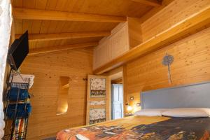a bedroom with wooden walls and a bed in a room at Il Campo di Nonno Giò in Spoleto