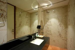 a bathroom with a sink and a mirror at Celebrant Hotel in Varanasi +101 photos