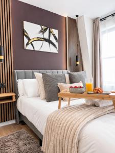 a living room with a couch and a table at Flat 7 in central Bromley - underground parking in Bromley