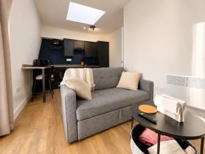 a living room with a couch and a table at Flat 7 in central Bromley - underground parking in Bromley