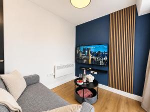 a living room with a couch and a tv at Flat 7 in central Bromley - underground parking in Bromley