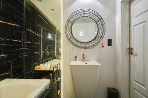 a bathroom with a sink and a mirror at Apartament Gold in Złotoryja +10 photos