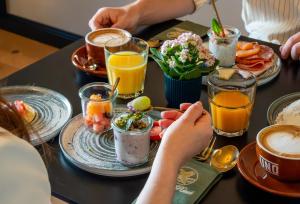 a table topped with plates of food and drinks at Limmathof Baden - Historisches Haus & Spa in Baden