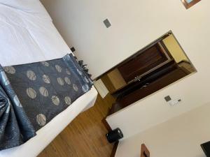 a view of a bedroom with a bed and a window at Peak Park Hotel in Mbeya +2 photos