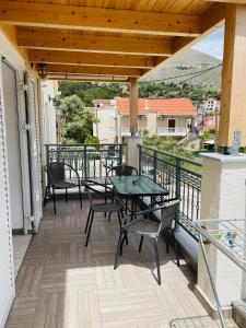 a patio with tables and chairs on a balcony at Starvillas Apartments and Studios in Agia Effimia