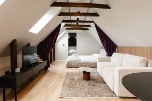 a living room with a white couch and a bed at Flowers House Sibiu in Sibiu