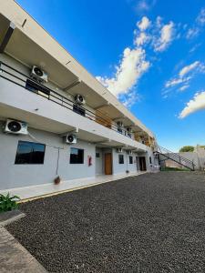 a white building with a balcony on the side of it at Hotel Catedral in Ribas do Rio Pardo
