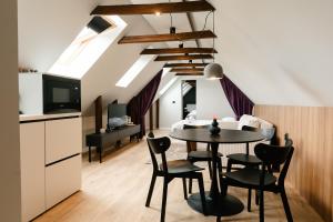 a kitchen and dining room with a table and chairs at Flowers House Sibiu in Sibiu