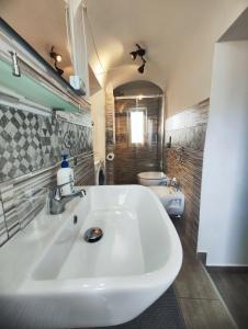 a bathroom with a white sink and a toilet at Two Rooms Bellini in Catania