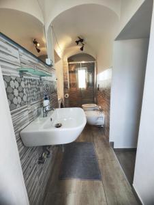 a bathroom with a sink and a toilet at Two Rooms Bellini in Catania