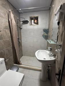 a bathroom with a shower and a sink at Nurata mountains Hayat guesthouse in Yukary-Ukhum +40 photos