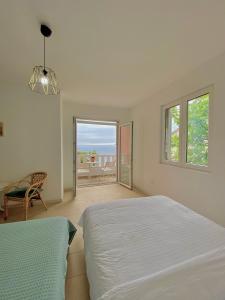 a bedroom with two beds and a view of the ocean at Budva Sky Sea - View Point in Budva