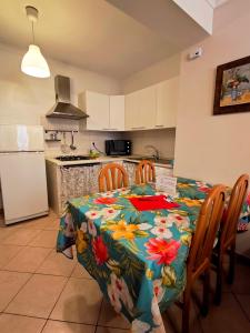 a kitchen with a table with a floral table cloth at Europa Casa Vacanze in Villetta Barrea
