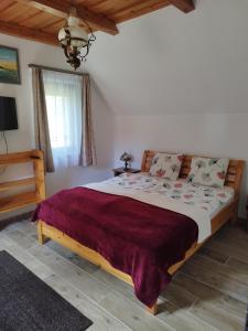 a bedroom with a large bed in a room at Klára Vendégház in Badacsonyörs