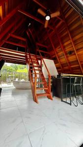 a wooden staircase in a room with a building at Pousada Estrela Dalva in Piracaia